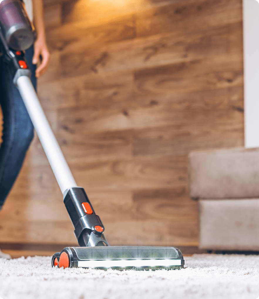 GettyImages-1455182972 (2) Vacuuming a carpeted floor with cordless vacuum.